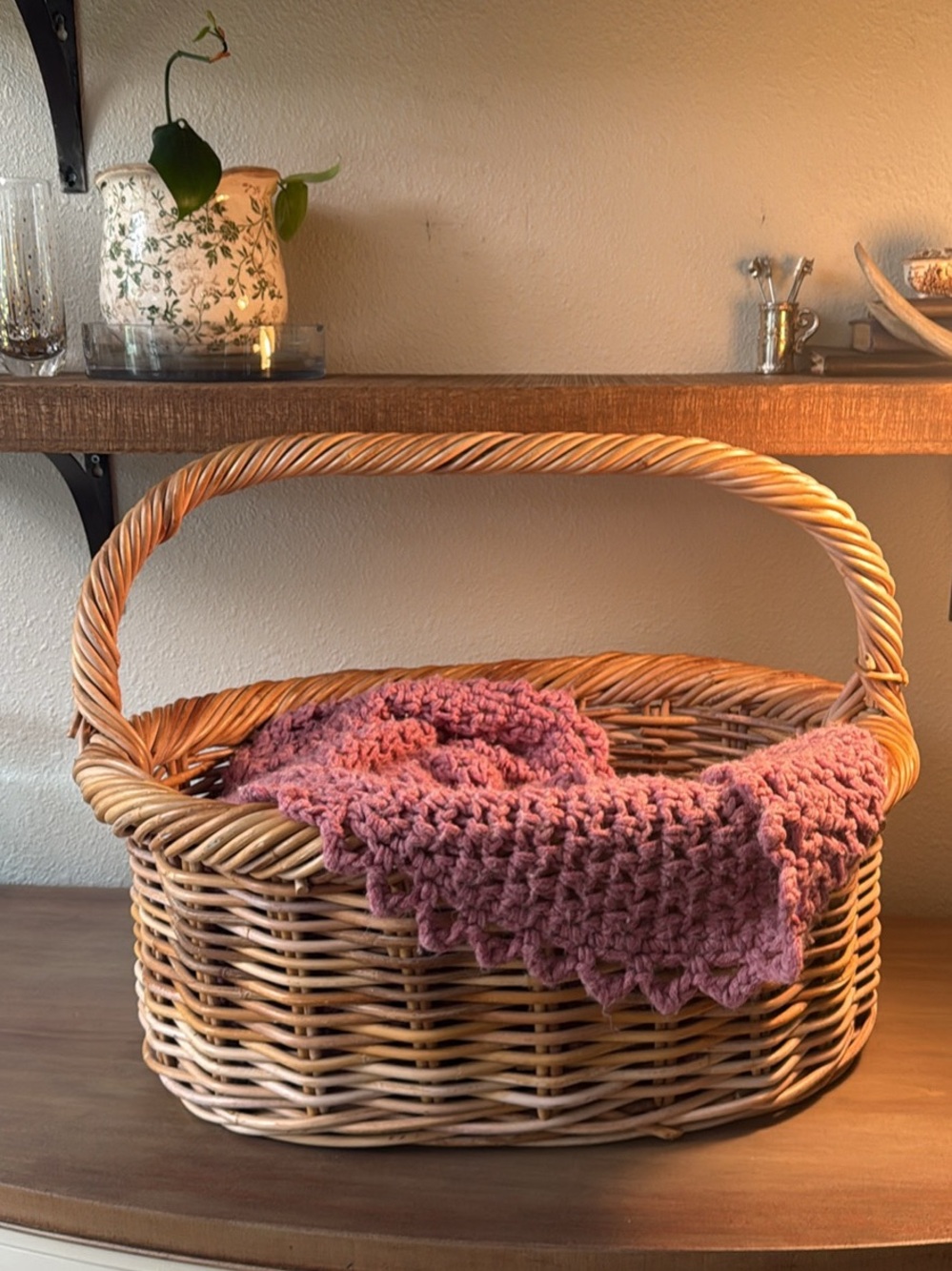 Woven Wicker Basket with Pink Crochet Throw